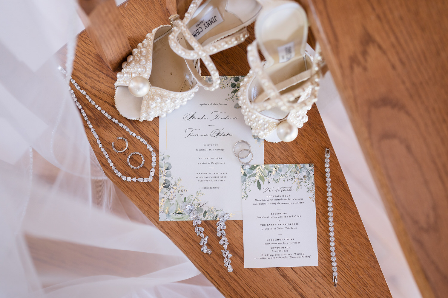 flat lay on the steps of Amalias childhood home with her shoes, invitation suite, jewelry, and veil.