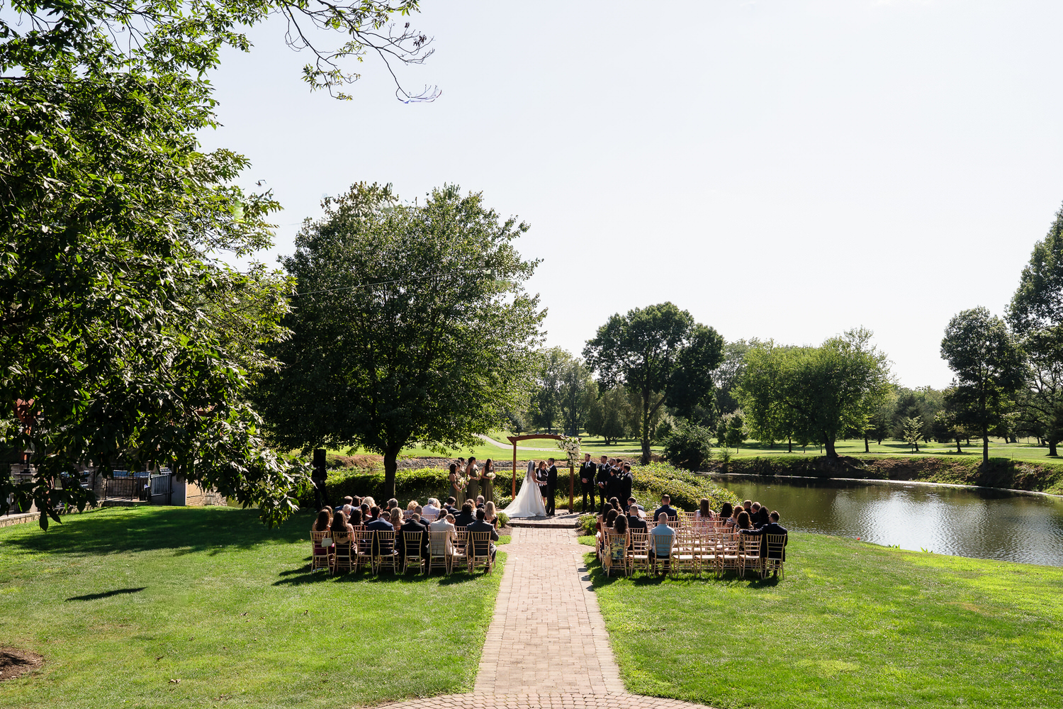 Wide shot of the wedding ceremony overlooking the water at Twin Lakes.