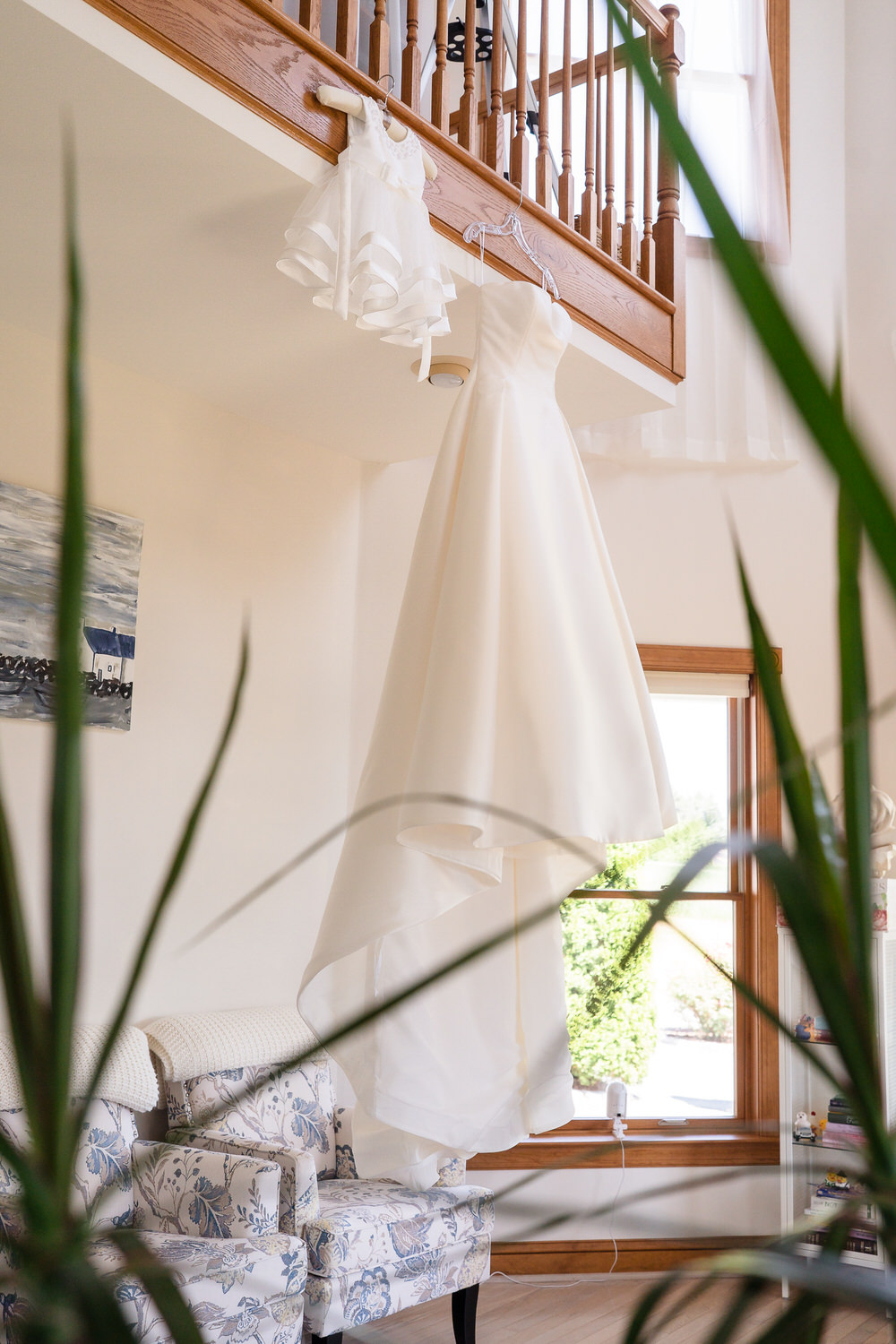 detail shot of bride's wedding dress next to her daughters dress