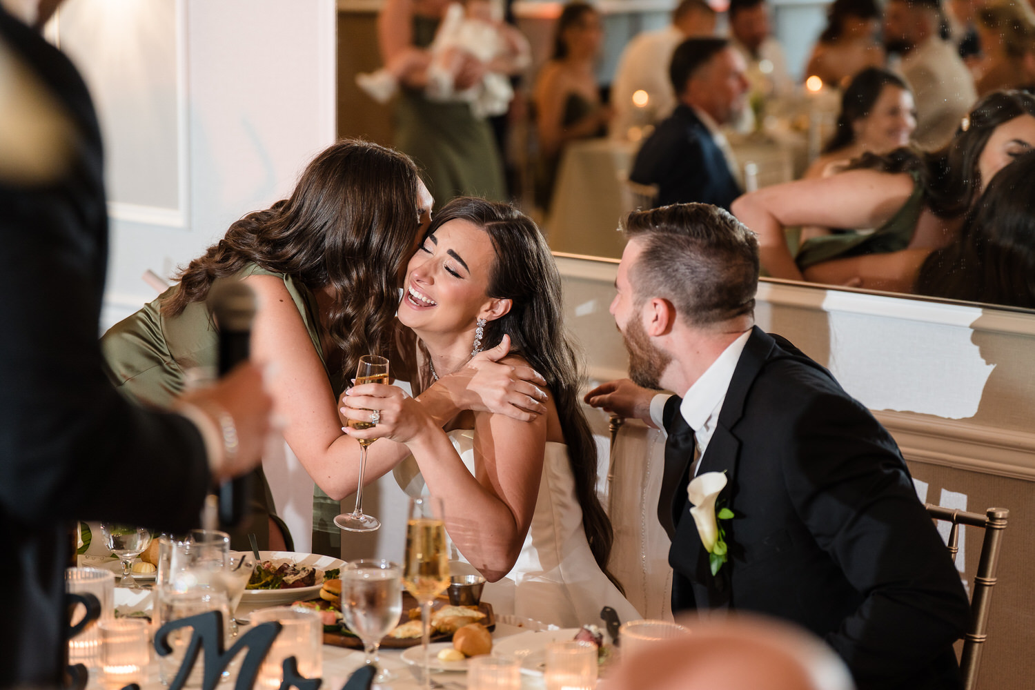 Bride hugging her sister after a speech at their wedding reception