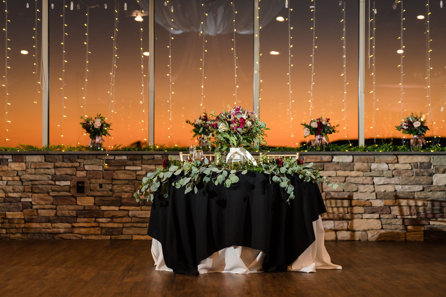 Golden Hour view of the Woodstone sweetheart table set against a dramatic orange sunset over the Blue Mountains.