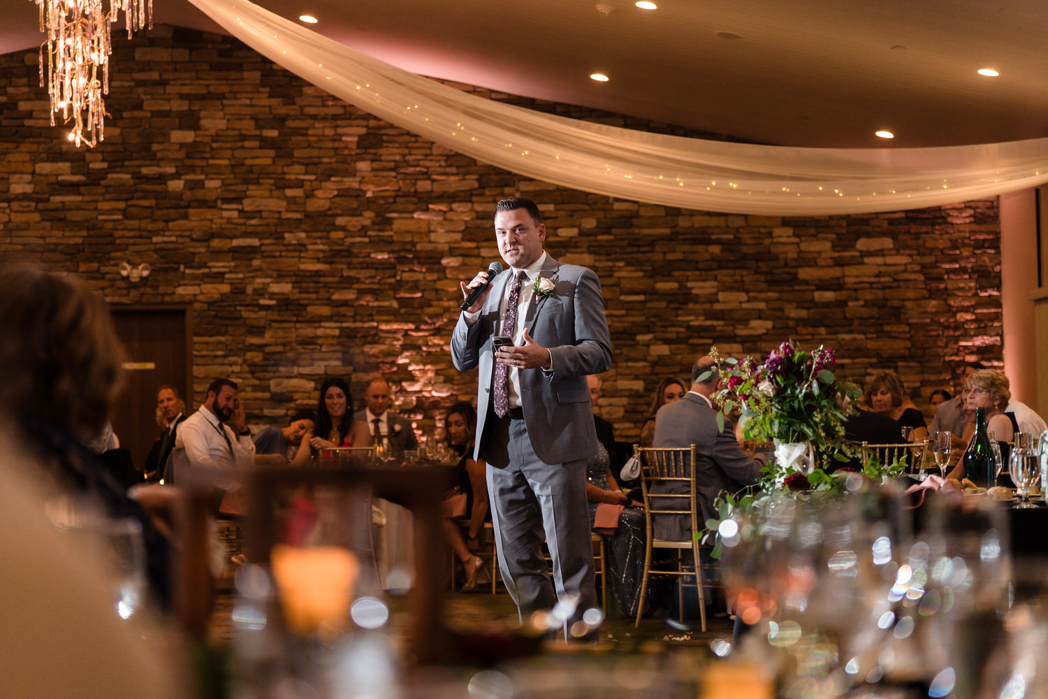 Documentary-style photograph of a groom giving a toast during a Lehigh Valley wedding reception.