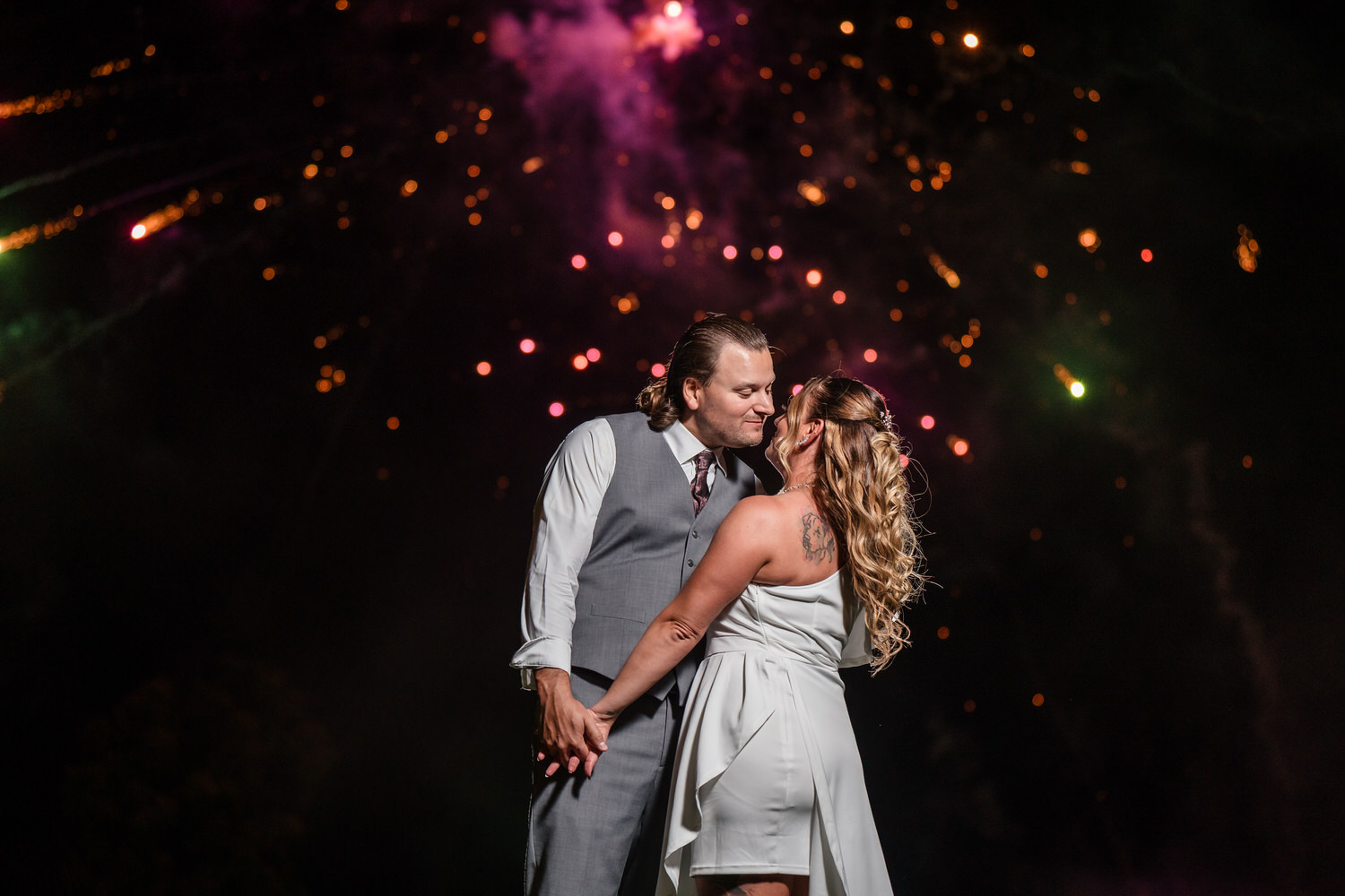 Candid "unscripted" moment of a bride and groom dancing during their outdoor wedding reception at Woodstone.