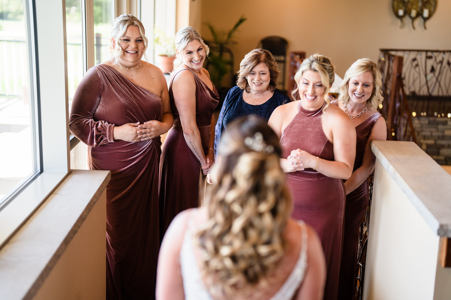 True-to-life bride portrait showcasing the vibrant pink and purple flowers of the Woodstone Country Club gardens.