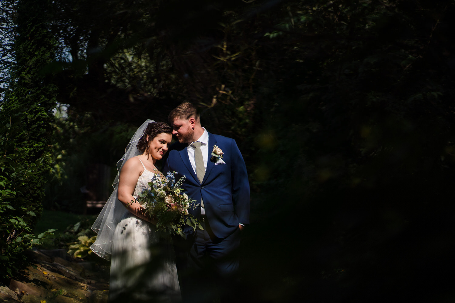 high contrast artistic portrait of bride and groom in full sun on their wedding day at Barn Swallow Farm