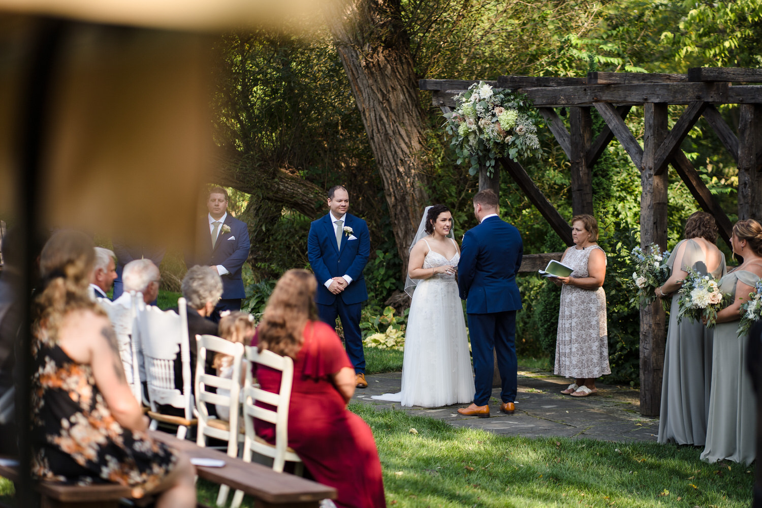 View of the wedding ceremony from the back of the seating area.