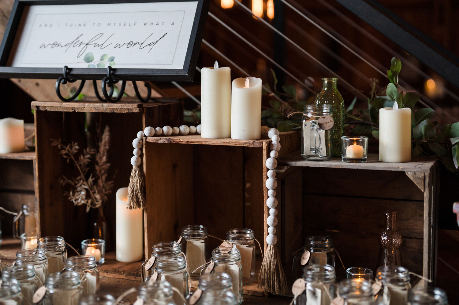 Reception detail featuring candles and rustic decor on a wooden crate.