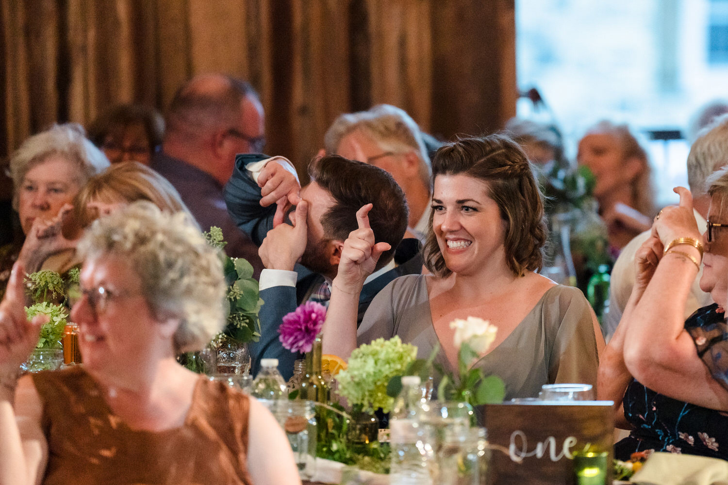 Guests laughing and enjoying the reception dinner at Barn Swallow Farm.
