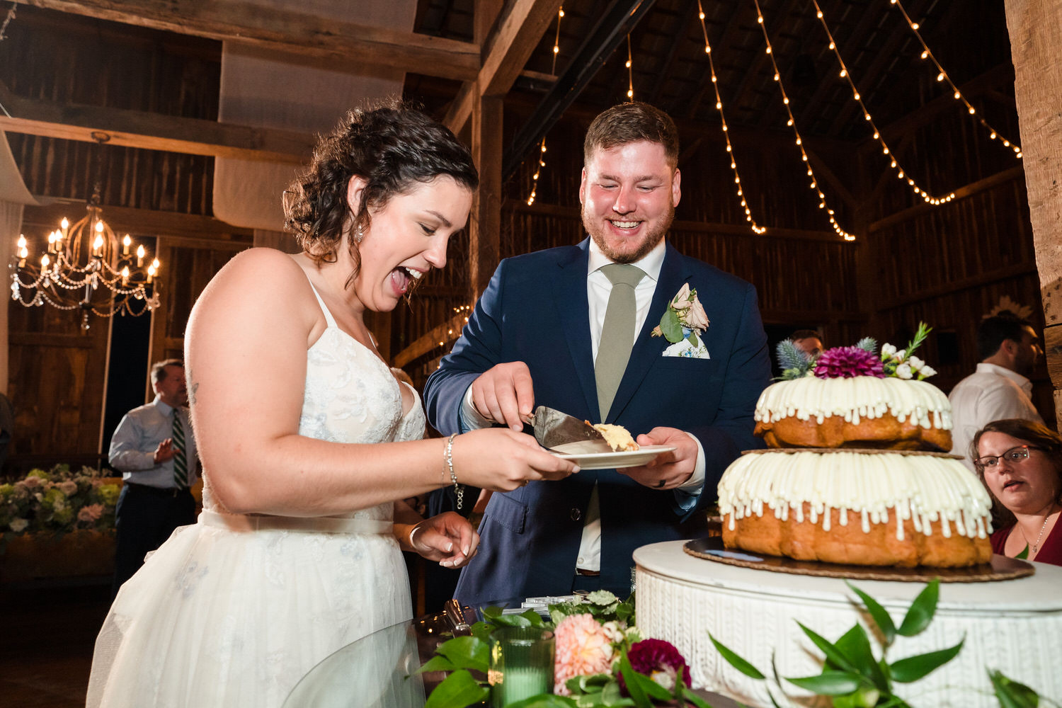 Candid moment of the couple laughing together during the cake cutting.