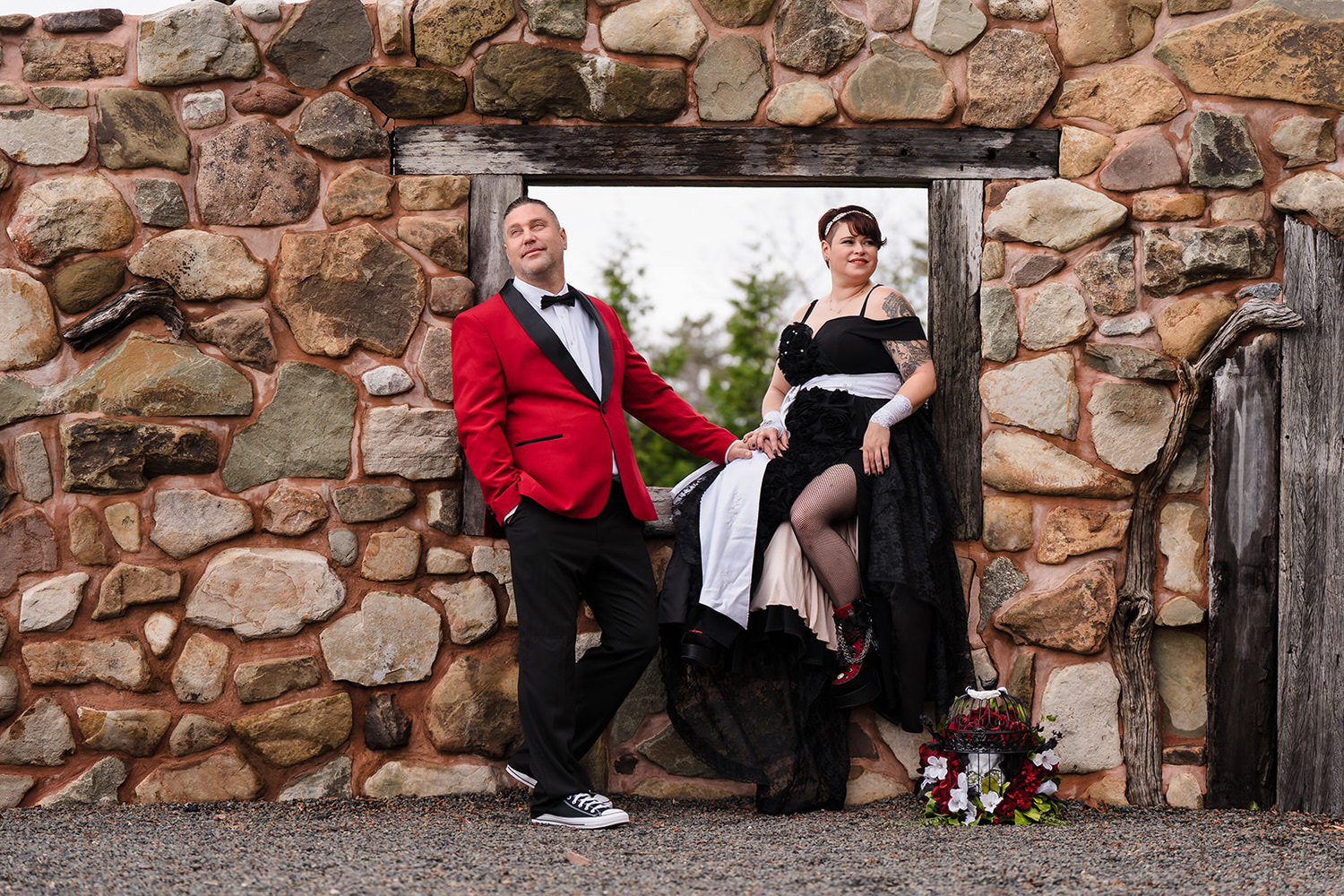 Bride and groom posing in an open stone window at the Kalahari Resort in the Poconos.