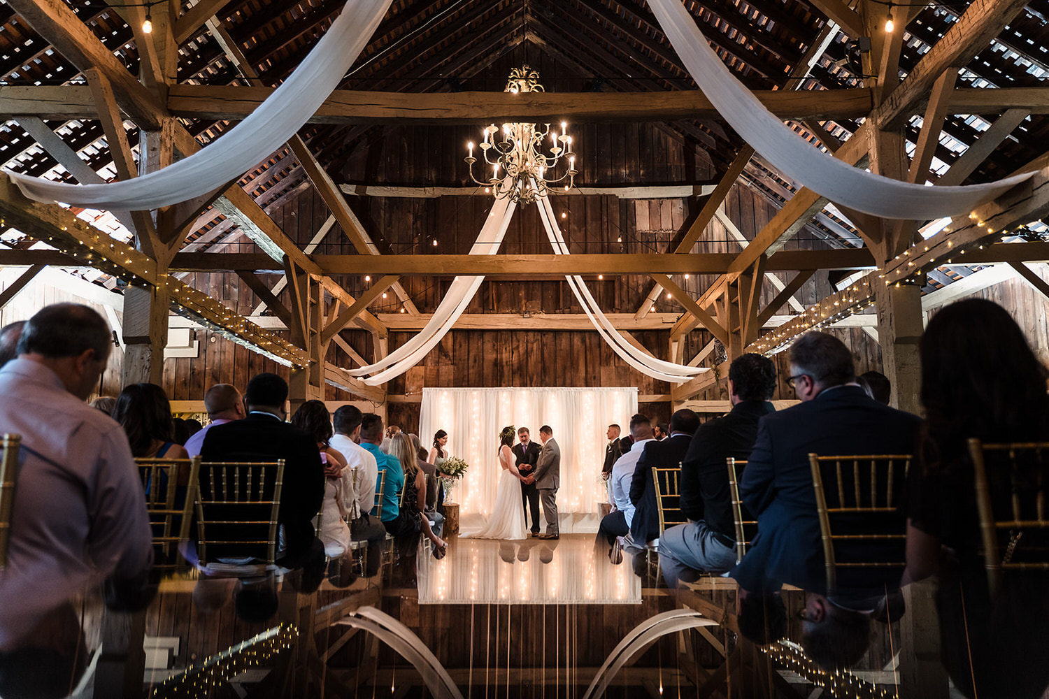 Outdoor wedding ceremony on a lakeside reflection deck at Memorytown in the Poconos.