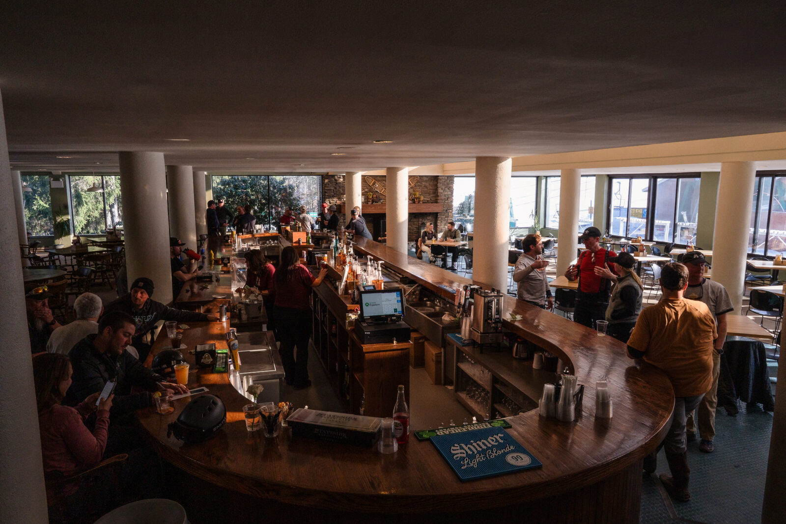 Lively ski lodge bar interior filled with guests at Elk Mountain Resort with a couple sitting at a table together