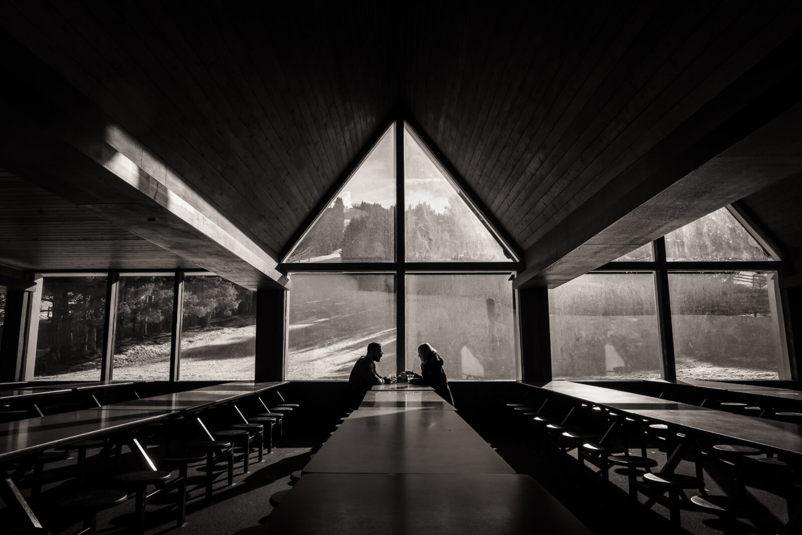 Black and white photo of A-frame lodge interior with couple silhouette at Elk Mountain