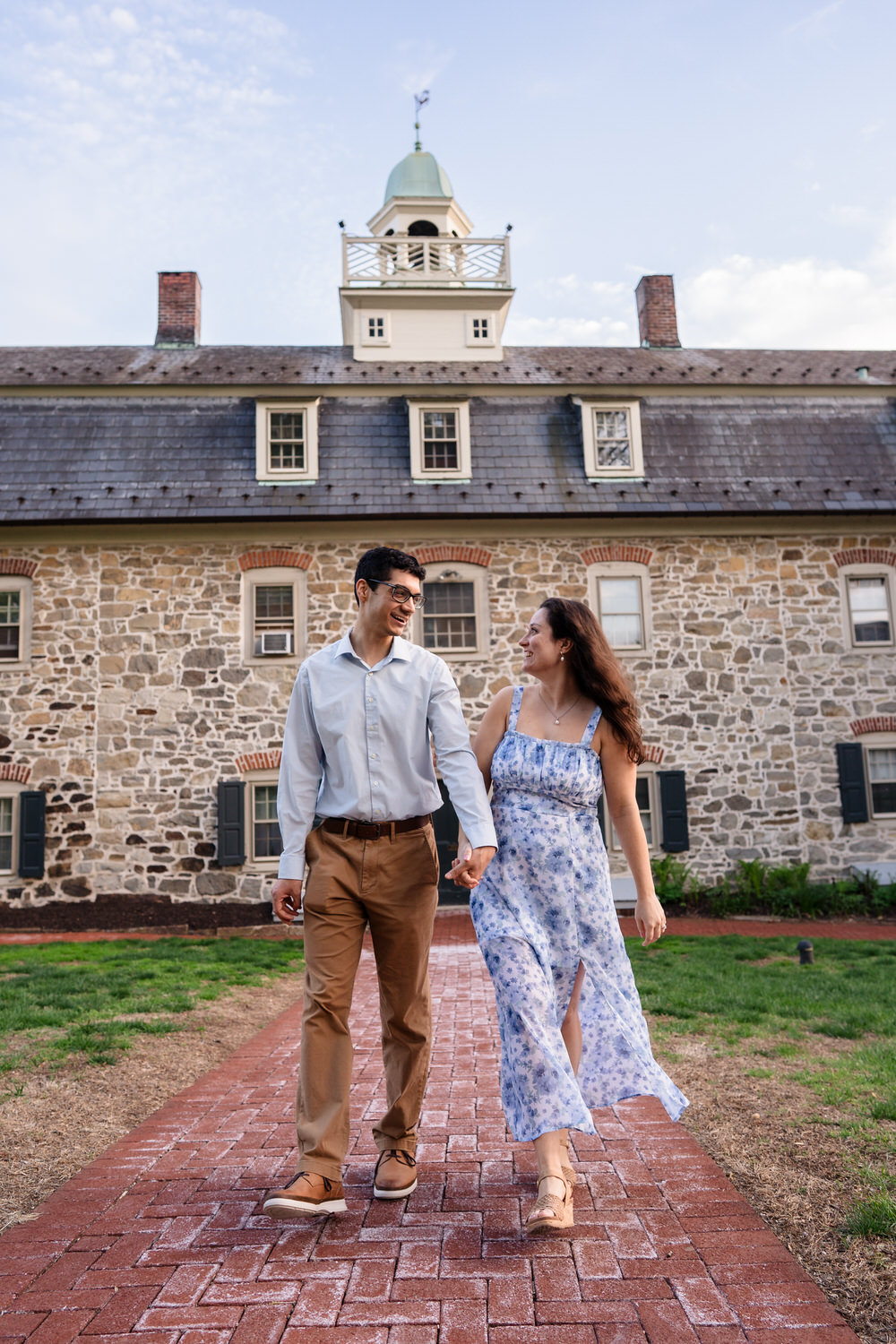 Walking shot of a couple in front of a historic Moravian University Building