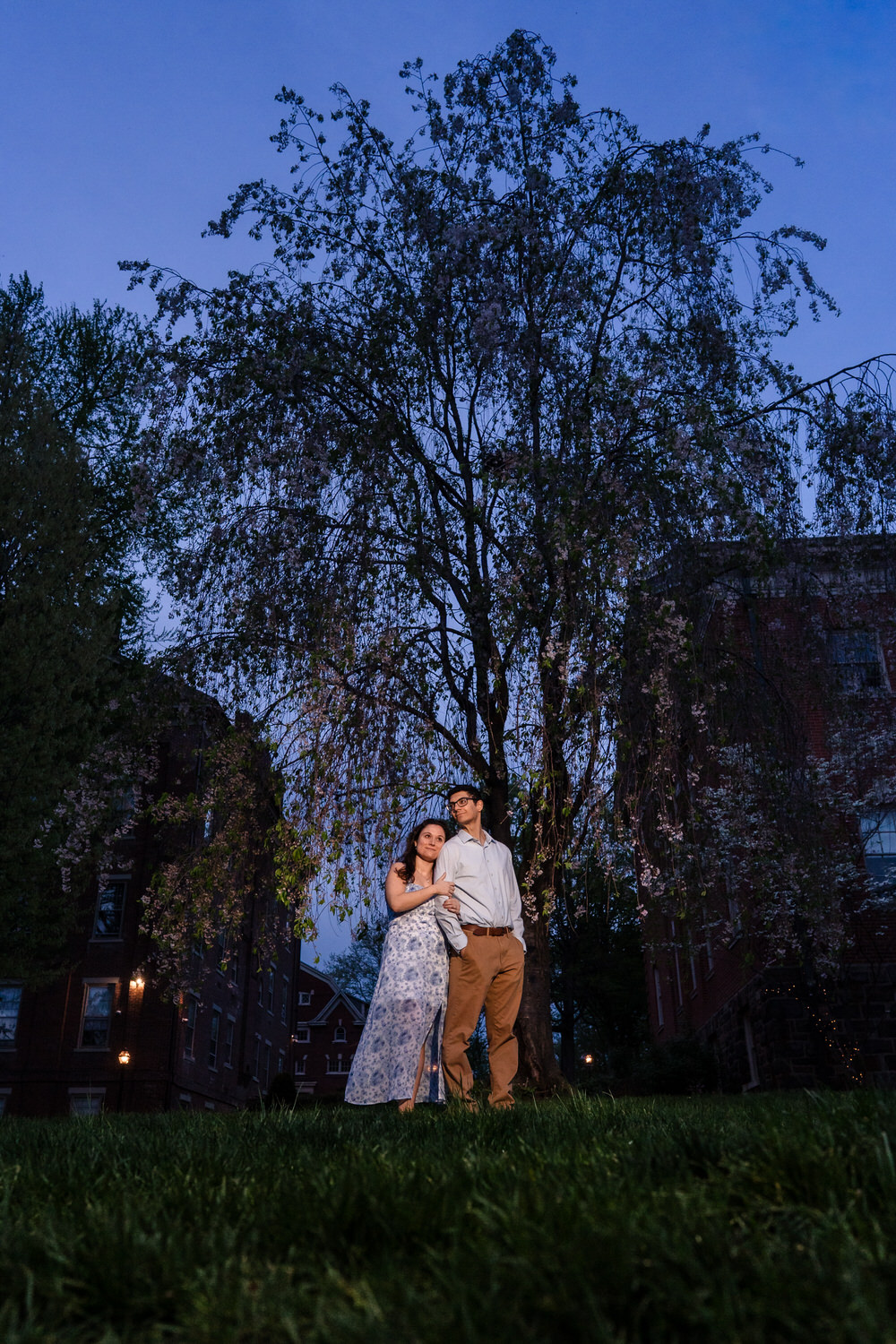 Couple shares a warm hug beneath weeping willow trees on the Moravian campus
