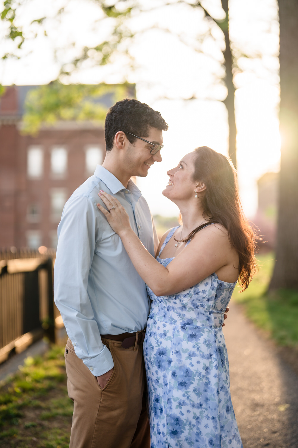 Couple looking at one another with a sunset glow behind them