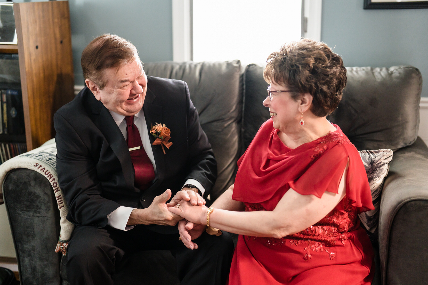 Groom sharing emotional moment with older woman before wedding ceremony