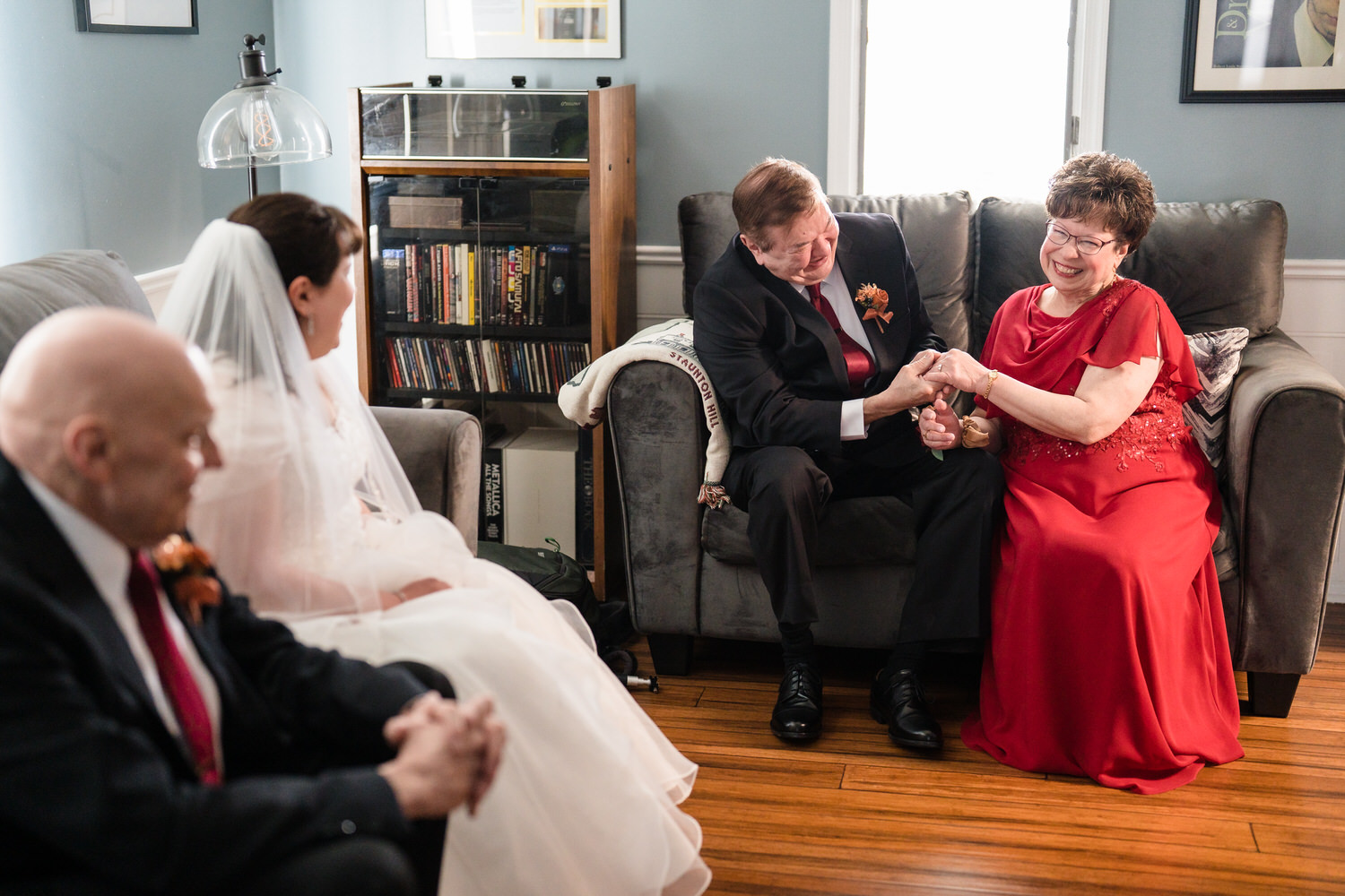 Bride and family seated together in living room before ceremony
