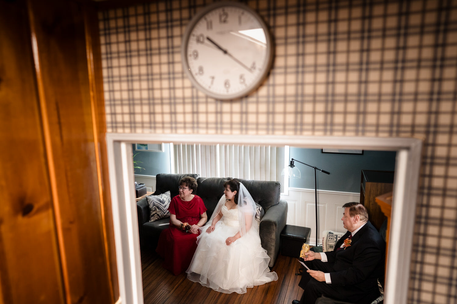 Bride getting ready in mirror reflection with wedding dress and veil