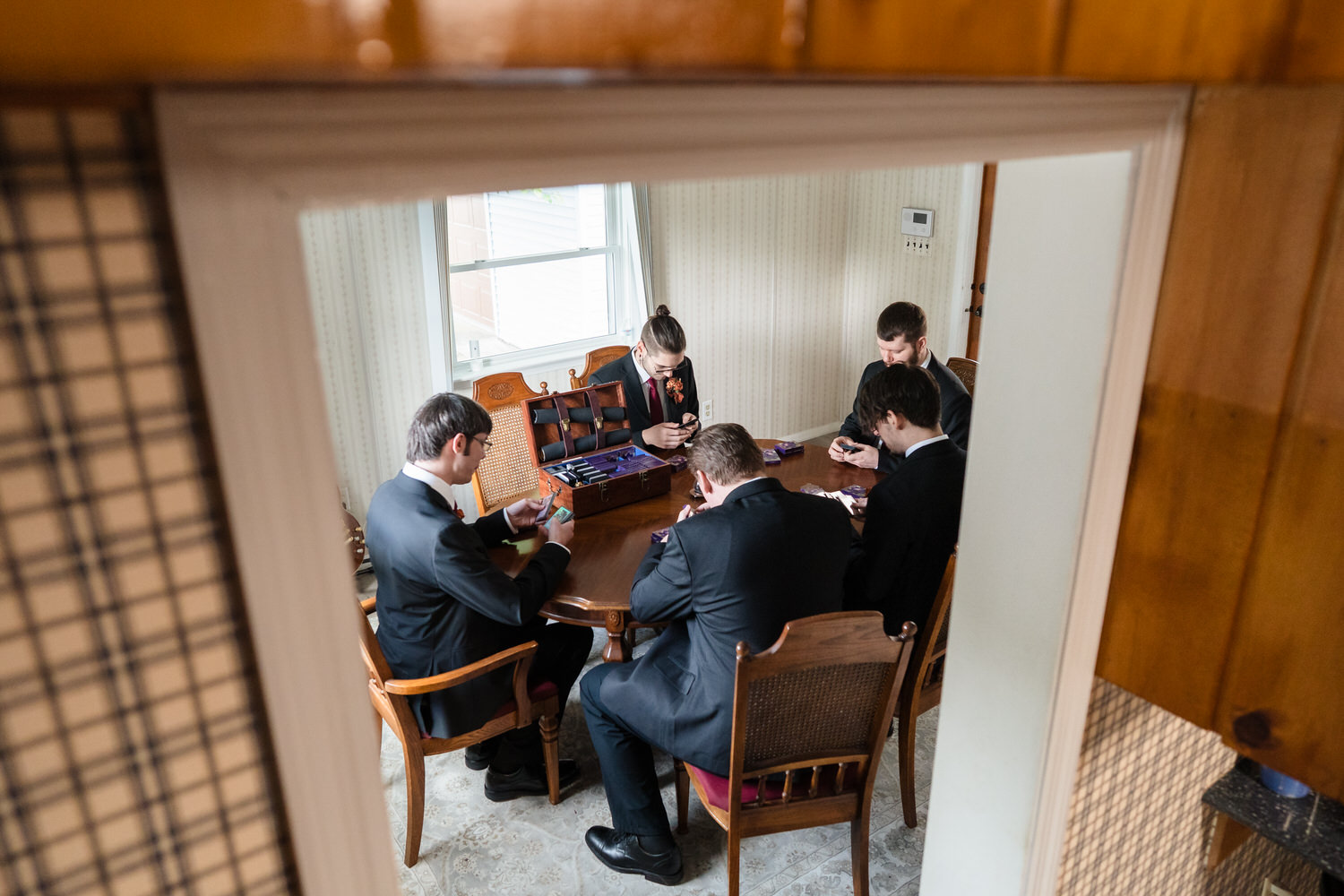 Groom and groomsmen gathered in home before wedding ceremony