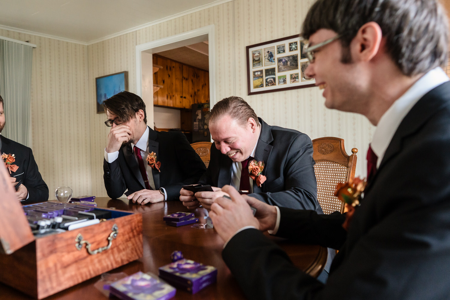 Groomsmen playing board game during wedding morning preparations