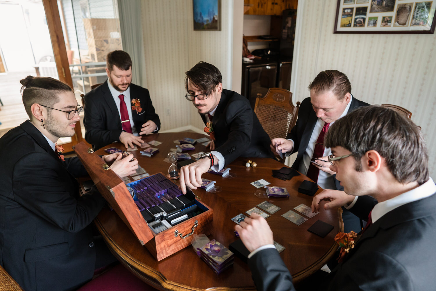 Groomsmen playing Magic the Gathering while getting ready before wedding ceremony