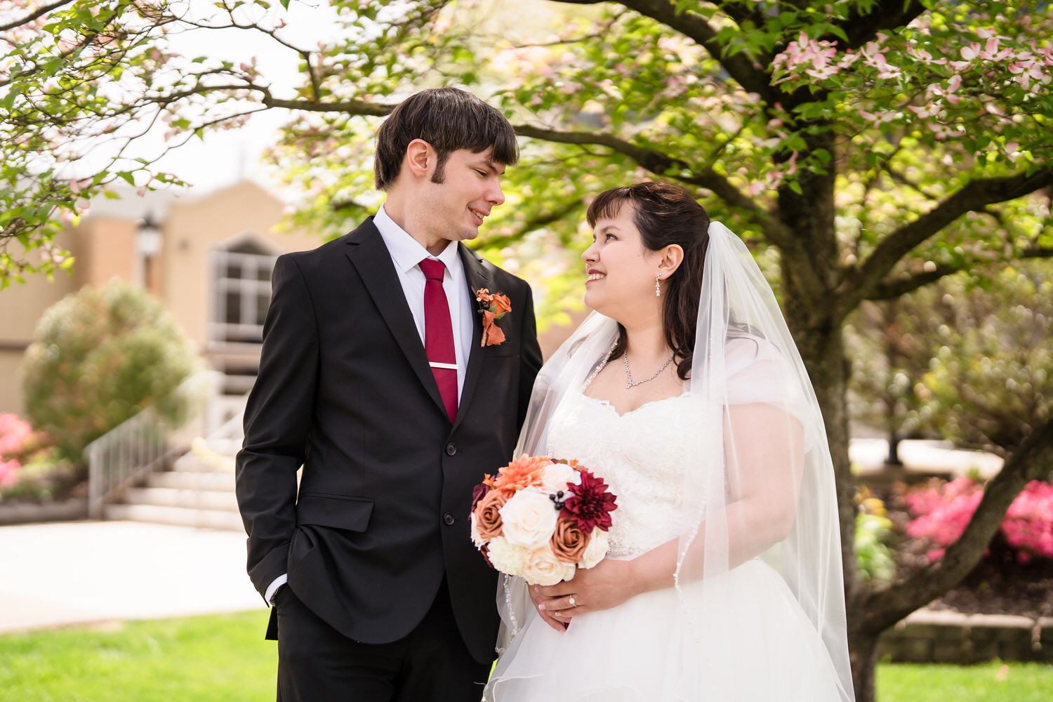 Bride and groom portrait outdoors with bouquet after church ceremony