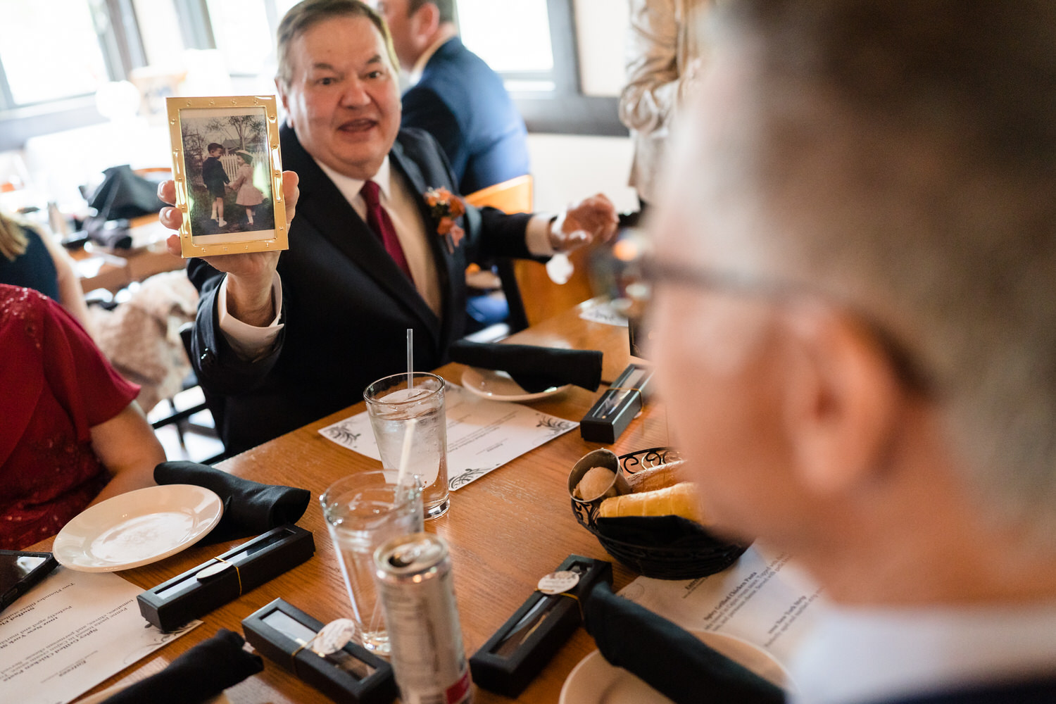 Wedding guest giving heartfelt toast during reception meal