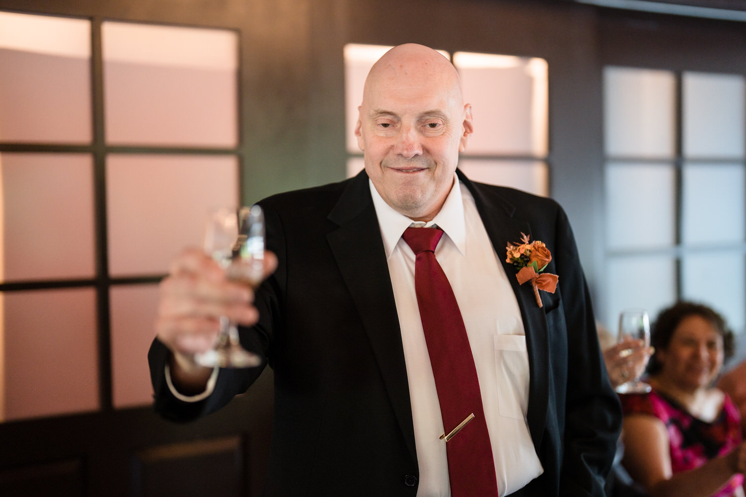 Man giving toast during wedding reception dinner