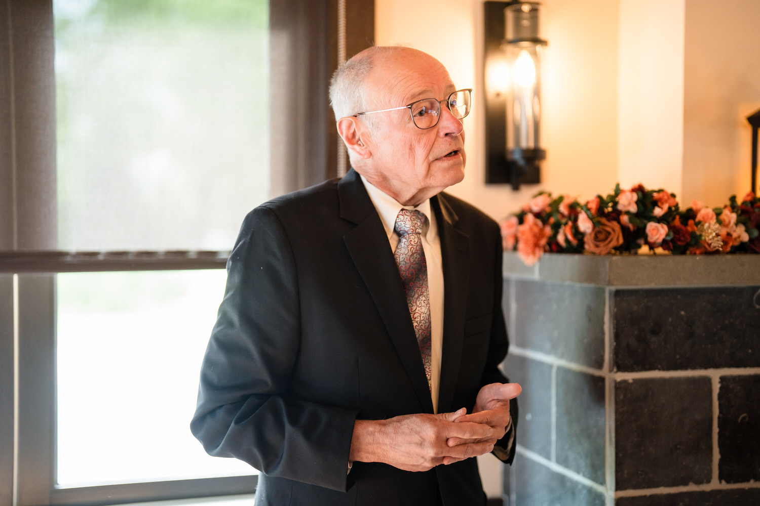 Wedding guest giving reception speech during indoor dinner