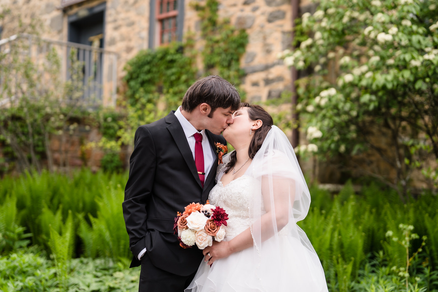 Bride and groom kissing during outdoor wedding portraits at Monocacy Park
