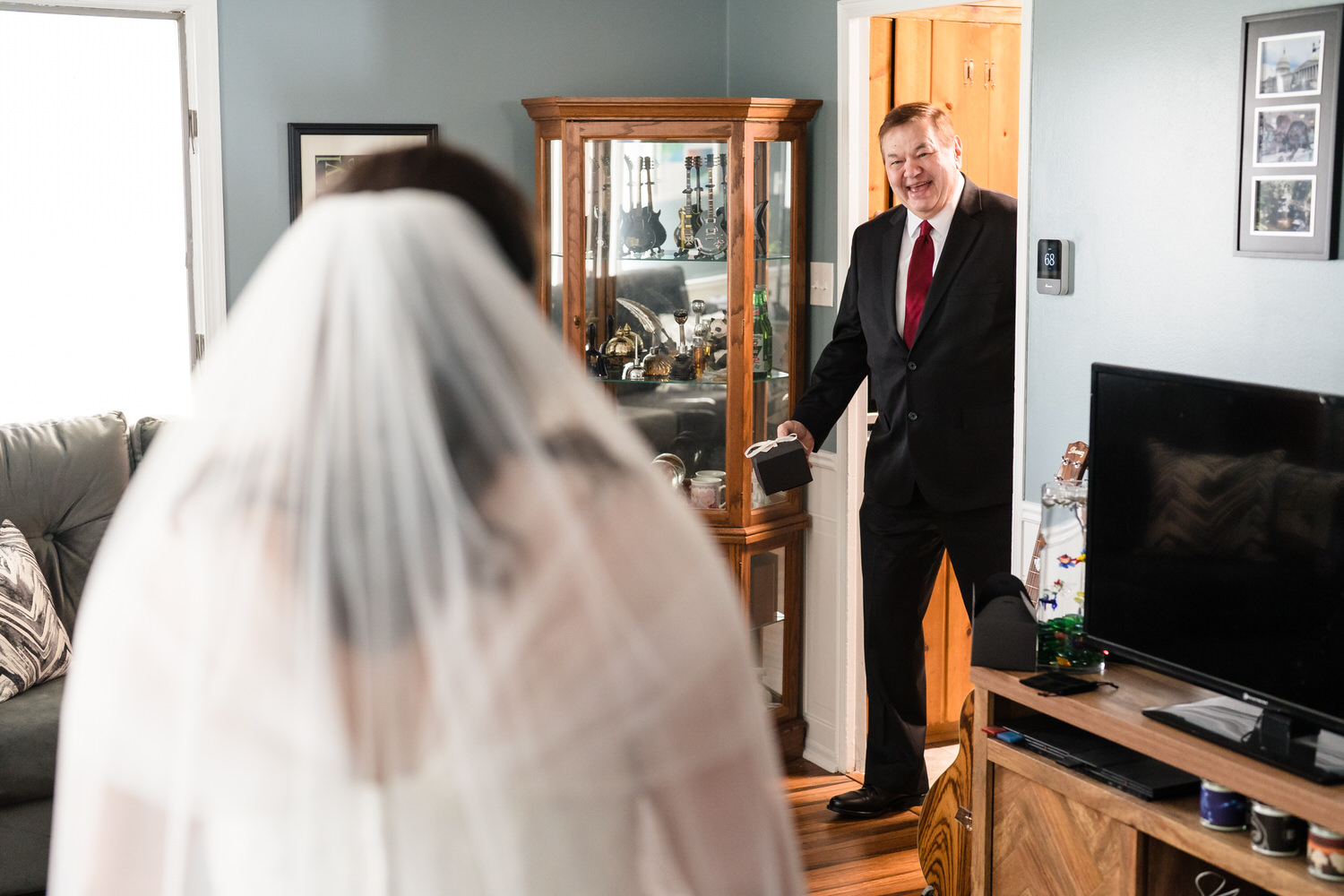 Bride and groom seen through mirror during wedding morning preparations